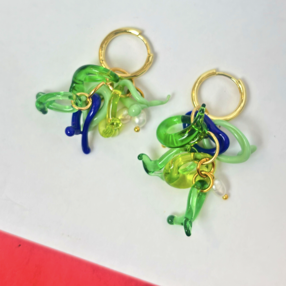 Colorful glass earrings with gold loops on a white background