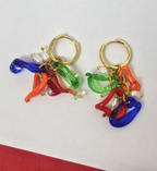 Colorful earrings with gold hoop and multicolored charms on a white background