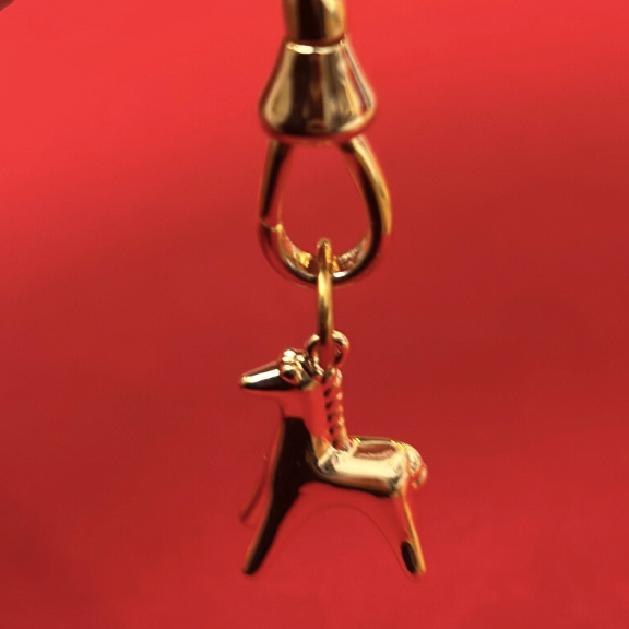 year of the horse gold charm on red background