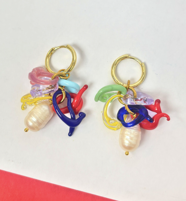 Colorful earrings with gold hooks on a white background