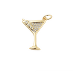 Gold martini glass pendant with embedded crystals on a white background