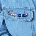 Colorful beaded hook attached to a blue denim jacket